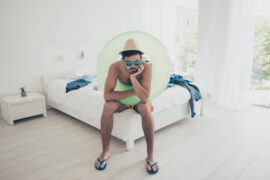 Man in beach attire sitting