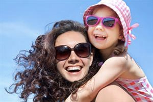 Happy woman and child outside wearing sunglasses
