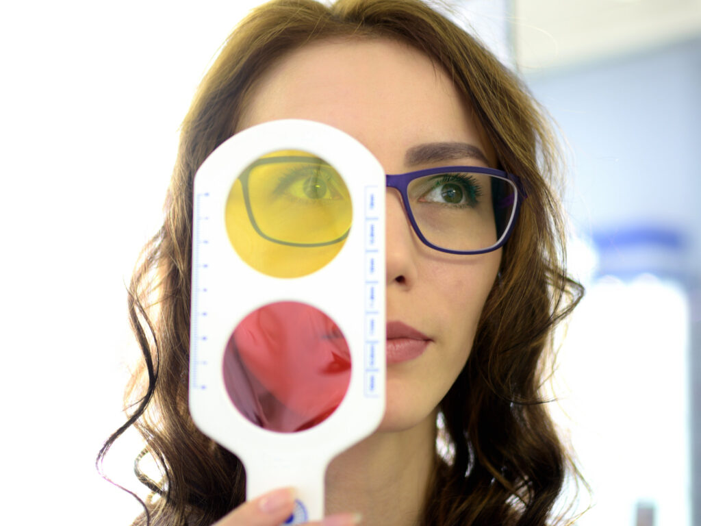 Woman wearing glasses having her eyes examined