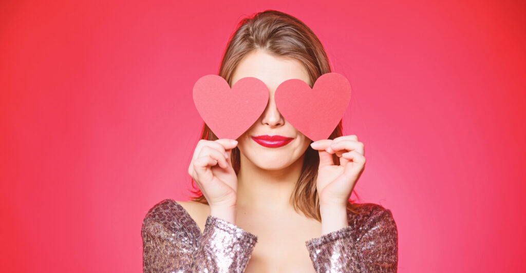 Valentines Day woman holding hearts over eyes